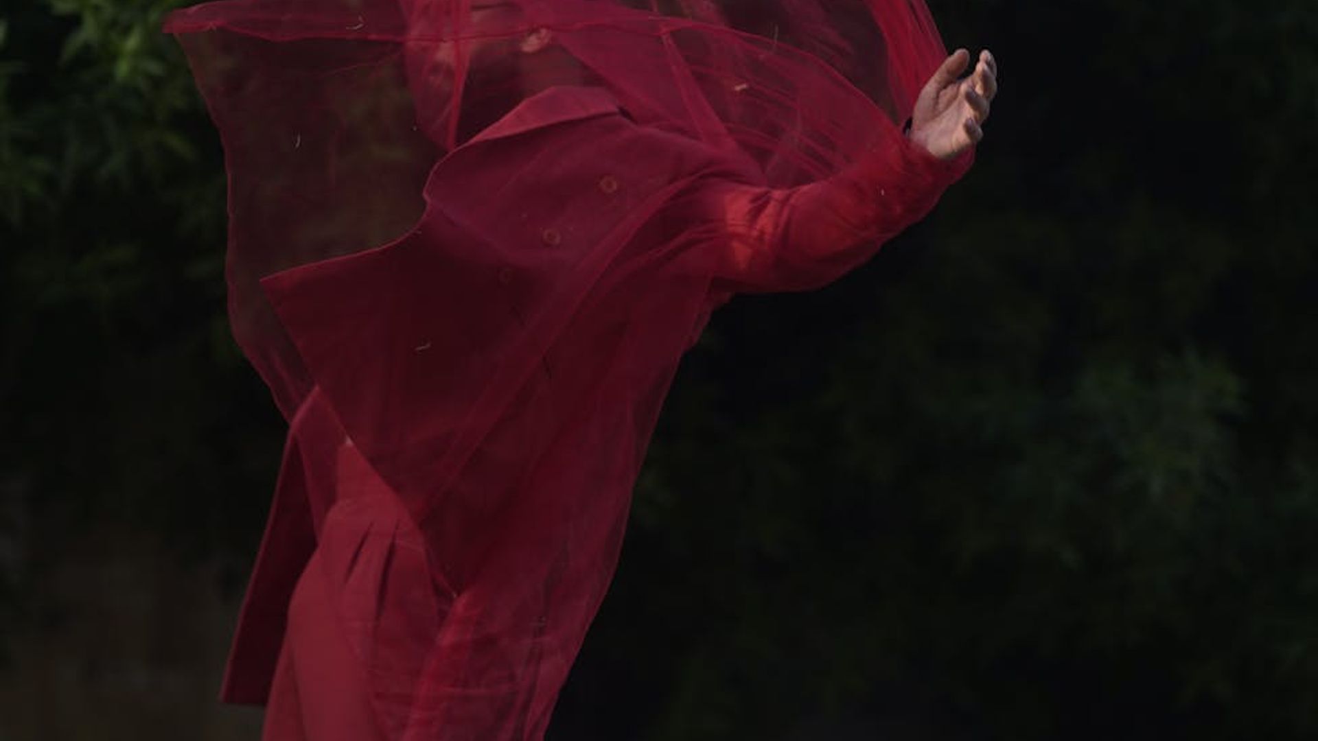 Abstract silhouette of a person in a dynamic, fluid motion pose.