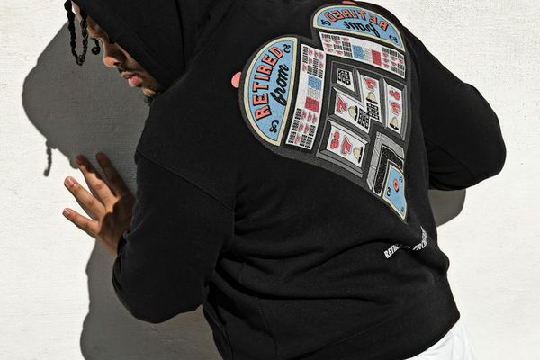 Person moving with grace against a minimalist dark background.